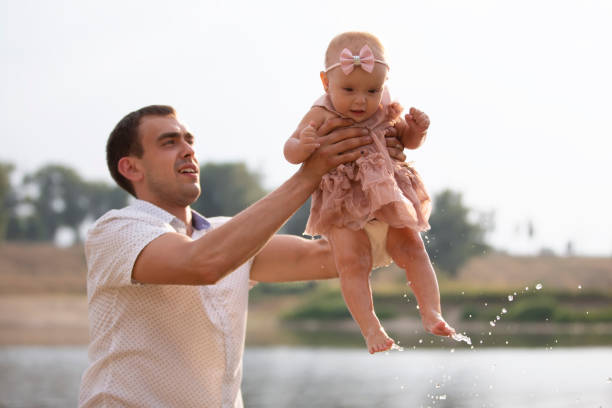 istock Happy dad throws up with his little daughter for a walk. Paternity. 1336145376