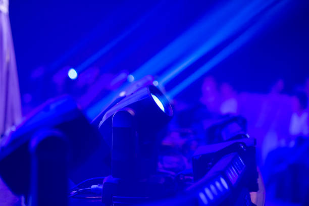 Blue stage background with spotlights lamps.