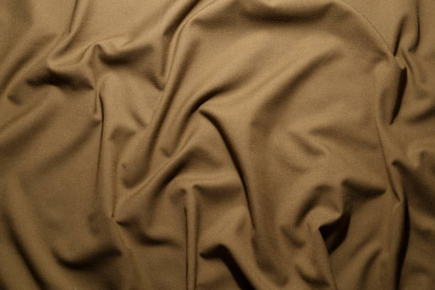istock crumpled khaki tan crumpled tan khaki canvas fabric - full frame background and texture 1336147096