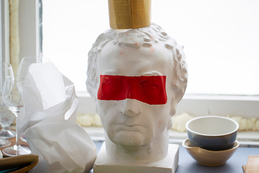 Caesar plaster head with red stripe on the eyes.