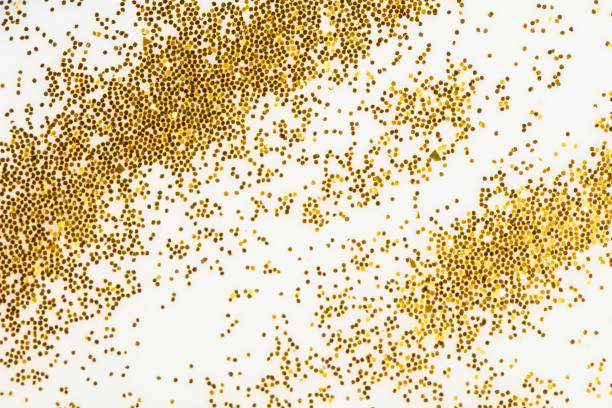 istock Festive or glamorous background. Gold sparkles scattered on a white background. 1336147902