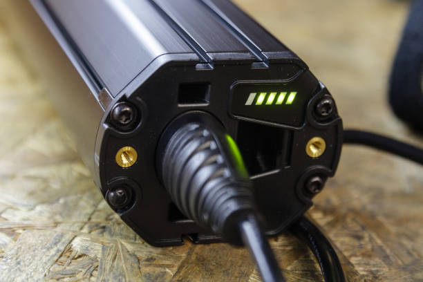 istock Electric bicycle lying in a table connected to a charger. 1336148316
