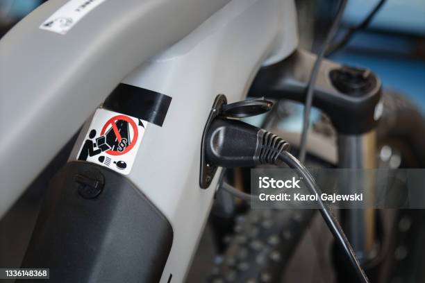 Close Up Shoto Of Electric Bicycle During Charging With Charger Plugged In Stock Photo - Download Image Now