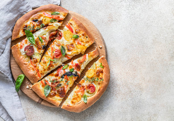 istock Pinsa with vegetables and cheese, concrete background. Traditional rome pizza. Top view. 1336150975