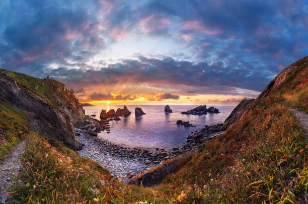 istock sunset on a rocky beach. Panoramic image of a beach 1336151112