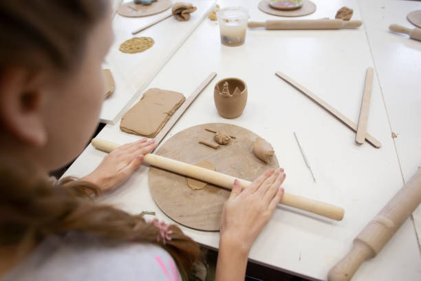 istock Master class in clay modeling. A teenage girl sculpts from clay. 1336151908