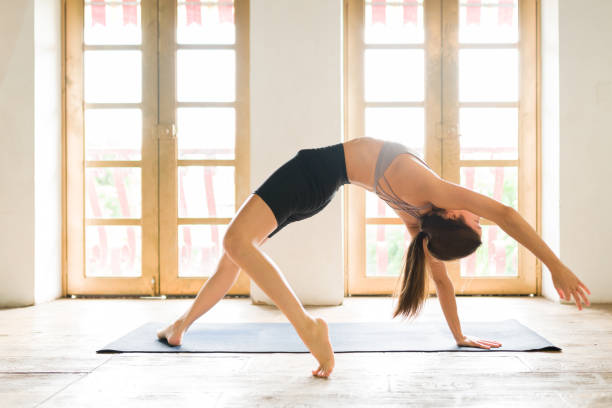istock Fit woman working on her body flexibility 1336153622