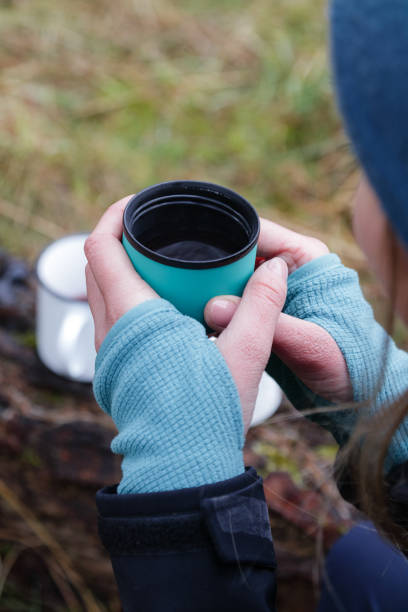 istock Woman drinking hot tea while hiking in the forest. 1336156818