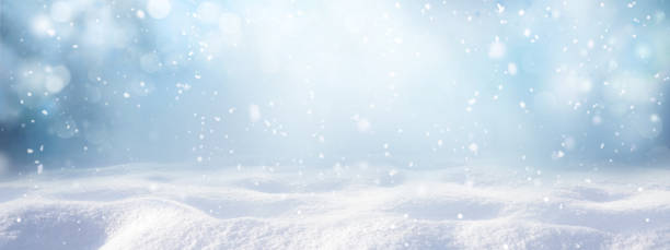 winter snow background with snowdrifts, with beautiful light and snow flakes on the blue sky. - snow stockfoto's en -beelden
