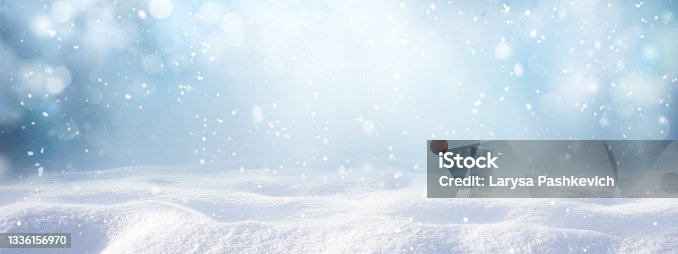 istock Winter snow background with snowdrifts, with beautiful light and snow flakes on the blue sky. 1336156970