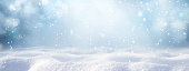 istock Winter snow background with snowdrifts, with beautiful light and snow flakes on the blue sky. 1336156970