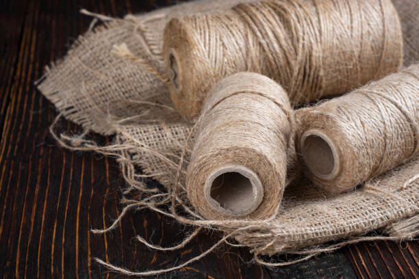 istock Linen threads and linen cloth on an old wooden table. 1336157040