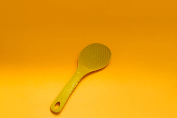 istock Kitchen Utensil: Yellow plastic rice spoon stock photo 1336159170