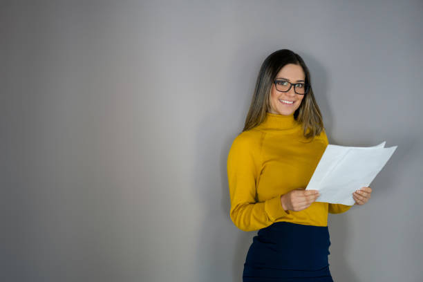 istock Studio shot of a business woman reading some documents 1336160951