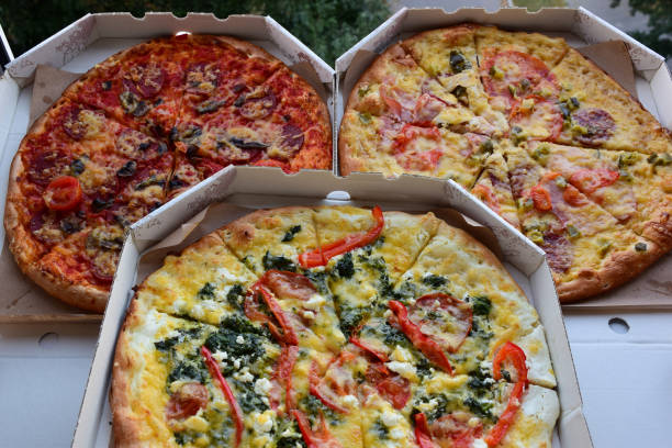 istock Three boxes of pizza of different types lie next to each other 1336161901