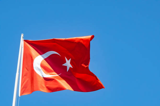 istock blue sky and waving turkish flag 1336165540