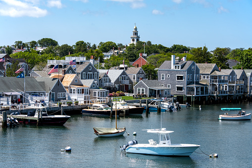 The village and one of the dock areas of Nantucket Harbor. Several pleasure craft and sportfishing boats are visible in dock or at anchor. \nNantucket, MA\n07/30/2021