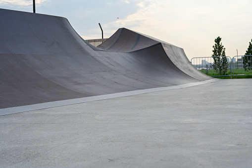 The skate park, rollerdrome, quarter and half pipe ramps. Extreme sport, youth urban culture for teen street activity. Close-up.