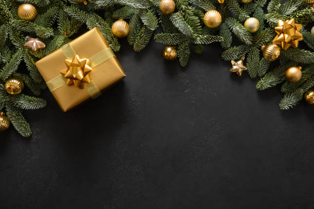 istock Christmas frame with golden gift and decorations on black. Xmas greeting card. . 1336169154