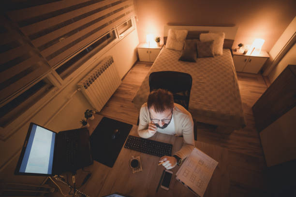 istock The man uses the computer at night, working late into the night. Late night work concept. New mormal concept. 1336169418