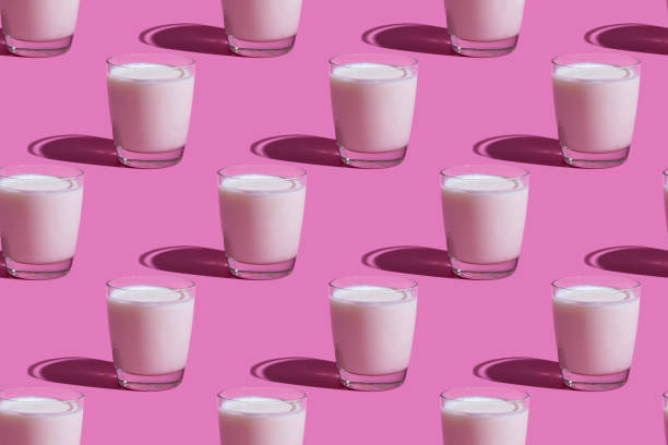 istock World Milk Day. Pattern on a pink background. A glass of milk. Pattern. 1336169445
