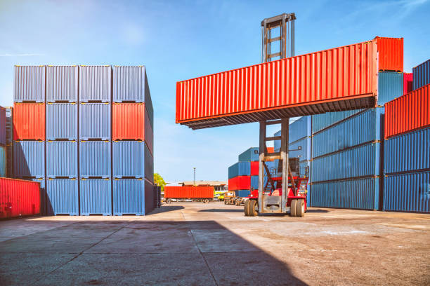 In shipping containers, there is a crane that lifts up the upper container. stock photo