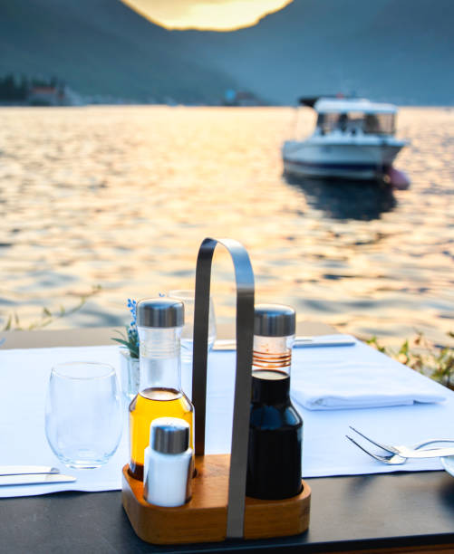 istock Restaurant table laid out awaiting customers at sunset by the waterside,Perast,Montenegro. 1336174568