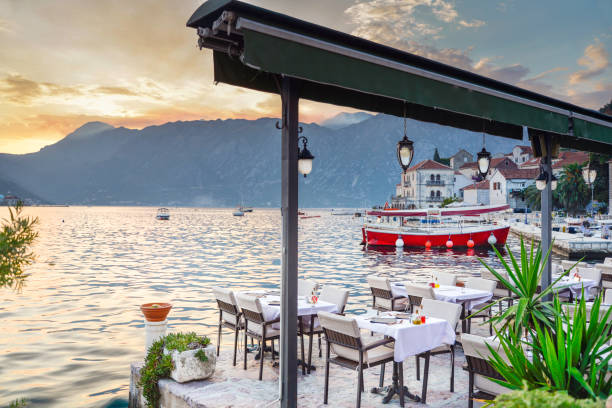 istock Restaurant tables laid out awaiting customers at sunset by the waterside,Perast,Montenegro. 1336174586