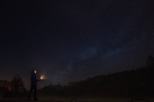 istock man at night with lantern and starry sky 1336175804