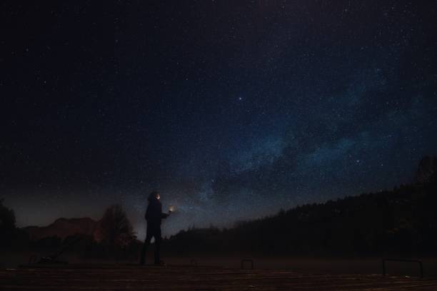 istock man at night with lantern and starry sky 1336175806