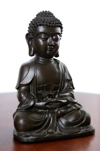 istock Buddha little black sculpture over red wood 1336176280