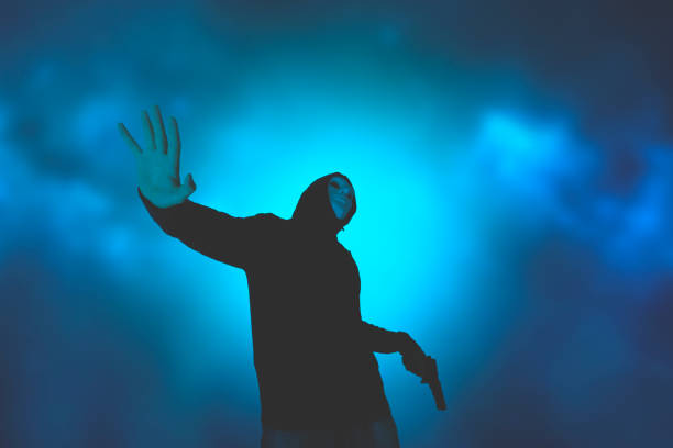 istock Hooded man with a gun falling down 1336176471