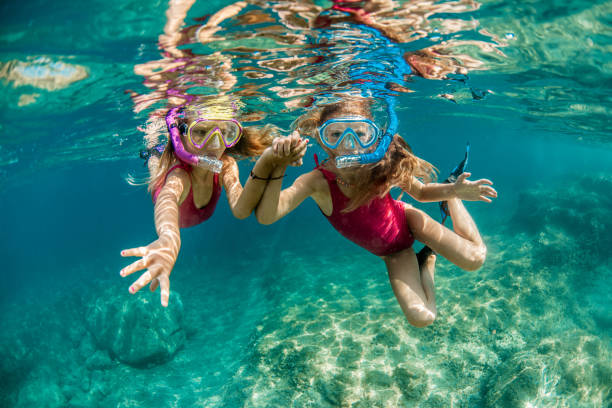 istock Girls having fun underwater 1336177486