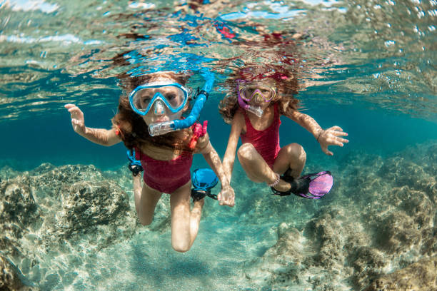 istock Sisters snorkeling and playing underwater 1336178267