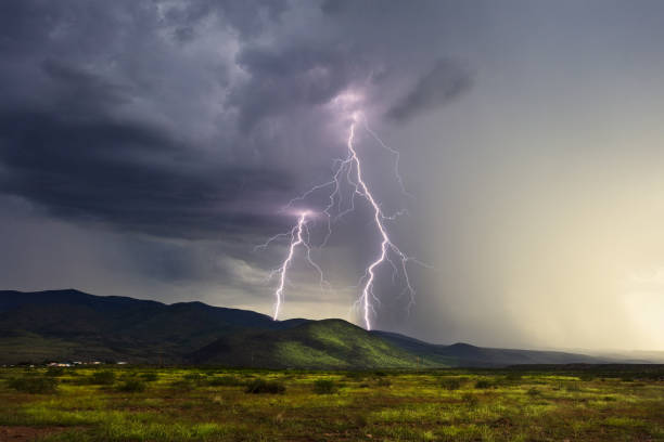 Lightning bolts strike a mountain in a storm