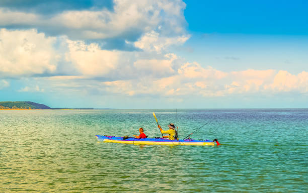 People Kayaking and canoeing in pristine and turquoise water at portuguese Island near Maputo Mozambique stock photo