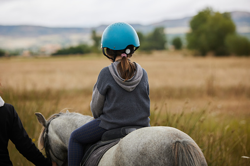 5 year old girl horseback riding.
