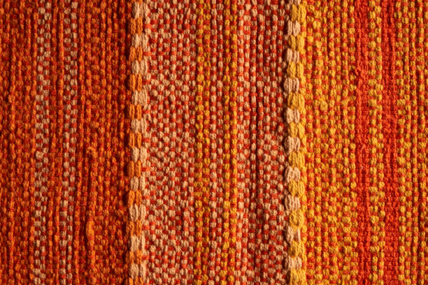 orange, red and yellow tapestry fabric texture background wallpaper orange, red and yellow tapestry fabric texture background wallpaper tapestry photos stock pictures, royalty-free photos & images