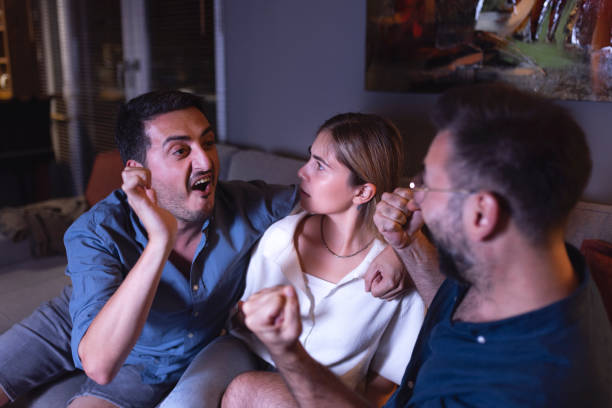 istock The young woman whose mood deteriorates between the two men watching the match 1336191230