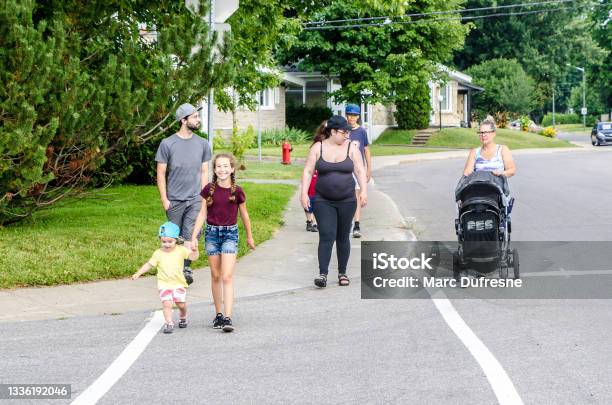 Three Generation Family Walking In Street Stock Photo - Download Image Now - 10-11 Years, 12-13 Years, 2-3 Years