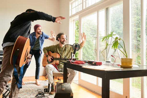 band waving to viewers online after a music set in a home studio - band 40s imagens e fotografias de stock