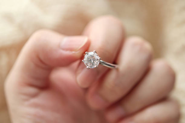 istock hand hold beautiful jewelry diamond ring 1336192175