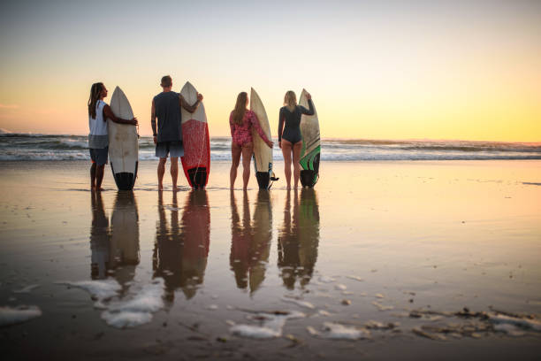 istock Gold Coast Friends Standing on Beach with Surfboards at Dawn 1336192721