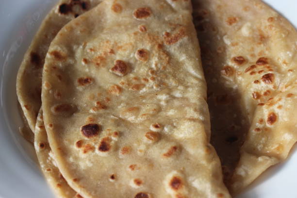 istock Closeup view of hand made plain bread in oil called paratha roti. 1336192768