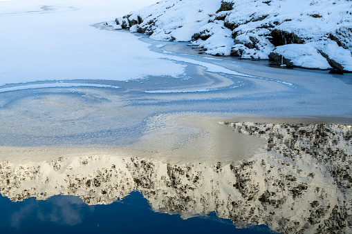 Snowcapped mountain peak reflection in water, Lofoten Islands, Norway