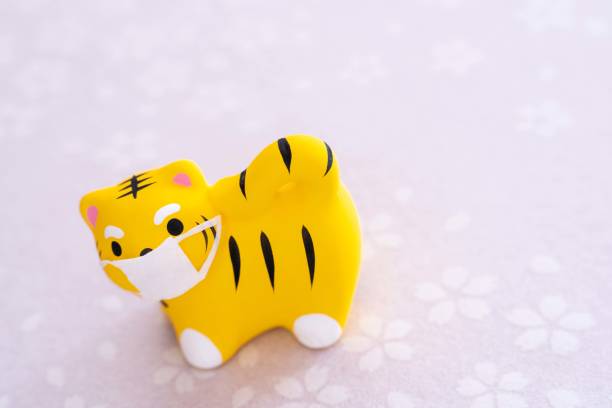 istock 2022 New Year's card tiger with mask image (Cherry blossoms, left） 1336199169