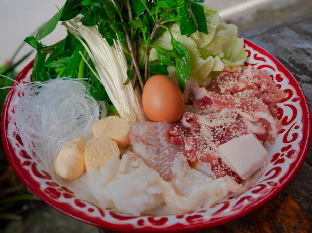 istock fresh marinated pork, fish, egg, tofu, vermicelli, and vegetable on plate, set of ingredients for Thai style barbecue grill or Moo Krata 1336199357