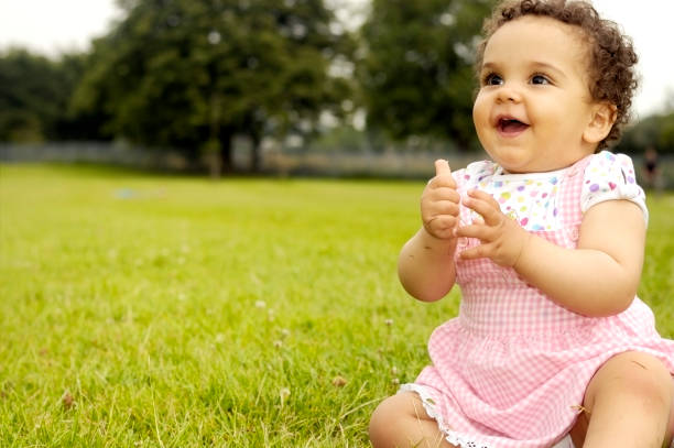 istock Baby Girl (1 year old) Sitting On Grass, Clapping Hands 133620003