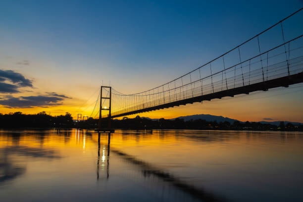 Night suspension bridge suspension bridge with river reflection at twilight Night suspension bridge suspension bridge with river reflection at twilight clifton stock pictures, royalty-free photos & images