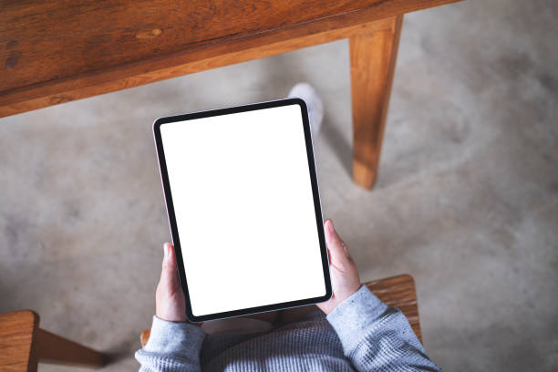 istock a woman holding digital tablet with blank white desktop screen 1336212599